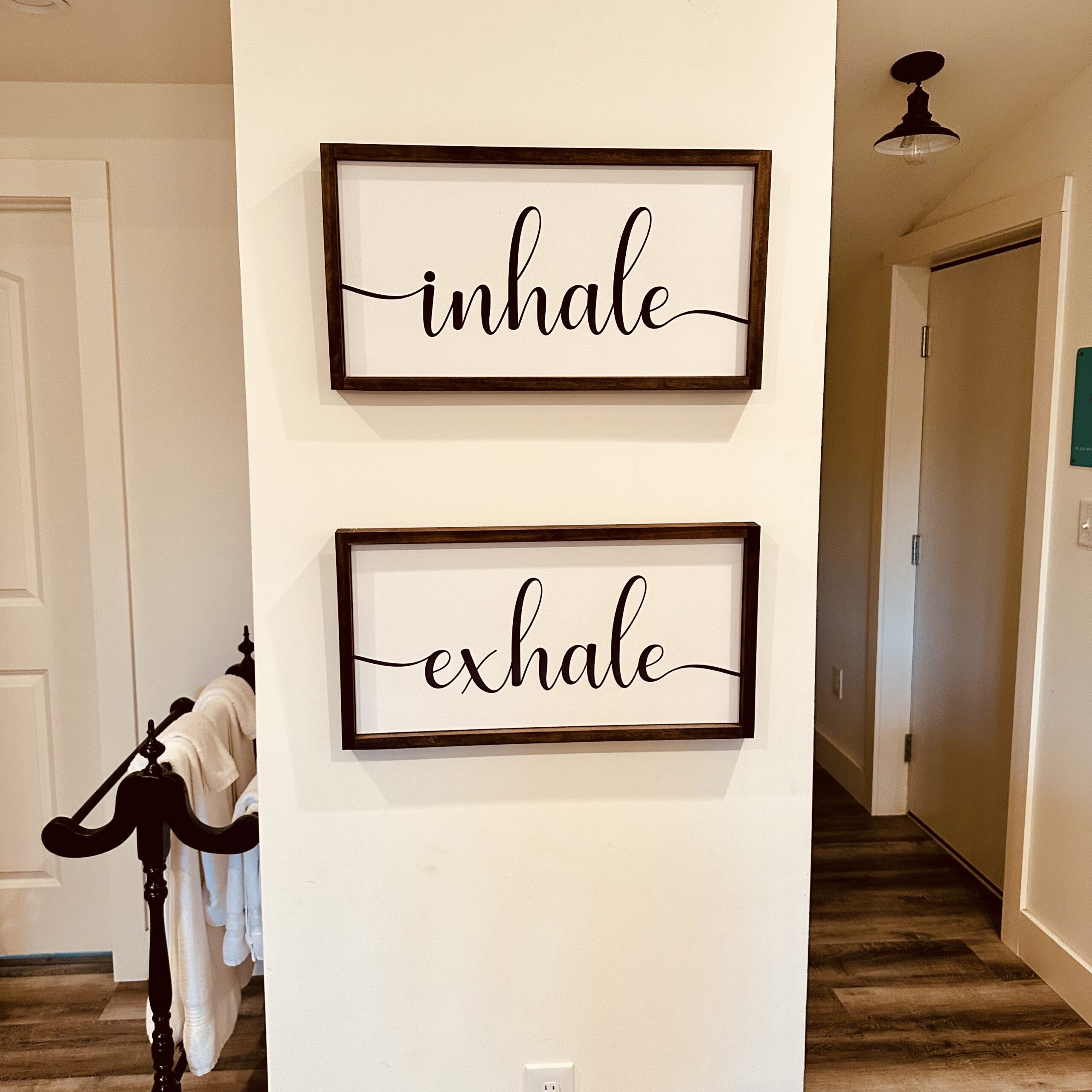 Wall art reading "inhale" and "exhale" inside a cozy loft apartment on a working horse farm in Georgetown, Kentucky. A peaceful space designed for rest, reflection, and simple living—perfectly capturing the calm of this Bourbon Trail retreat.