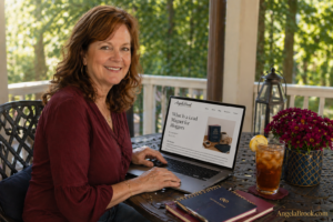 woman in her 50s sitting on sunny outdoor porch with laptop open showing a lead magnet for bloggers opt-in page, glass of iced tea with lemon nearby, trees in background